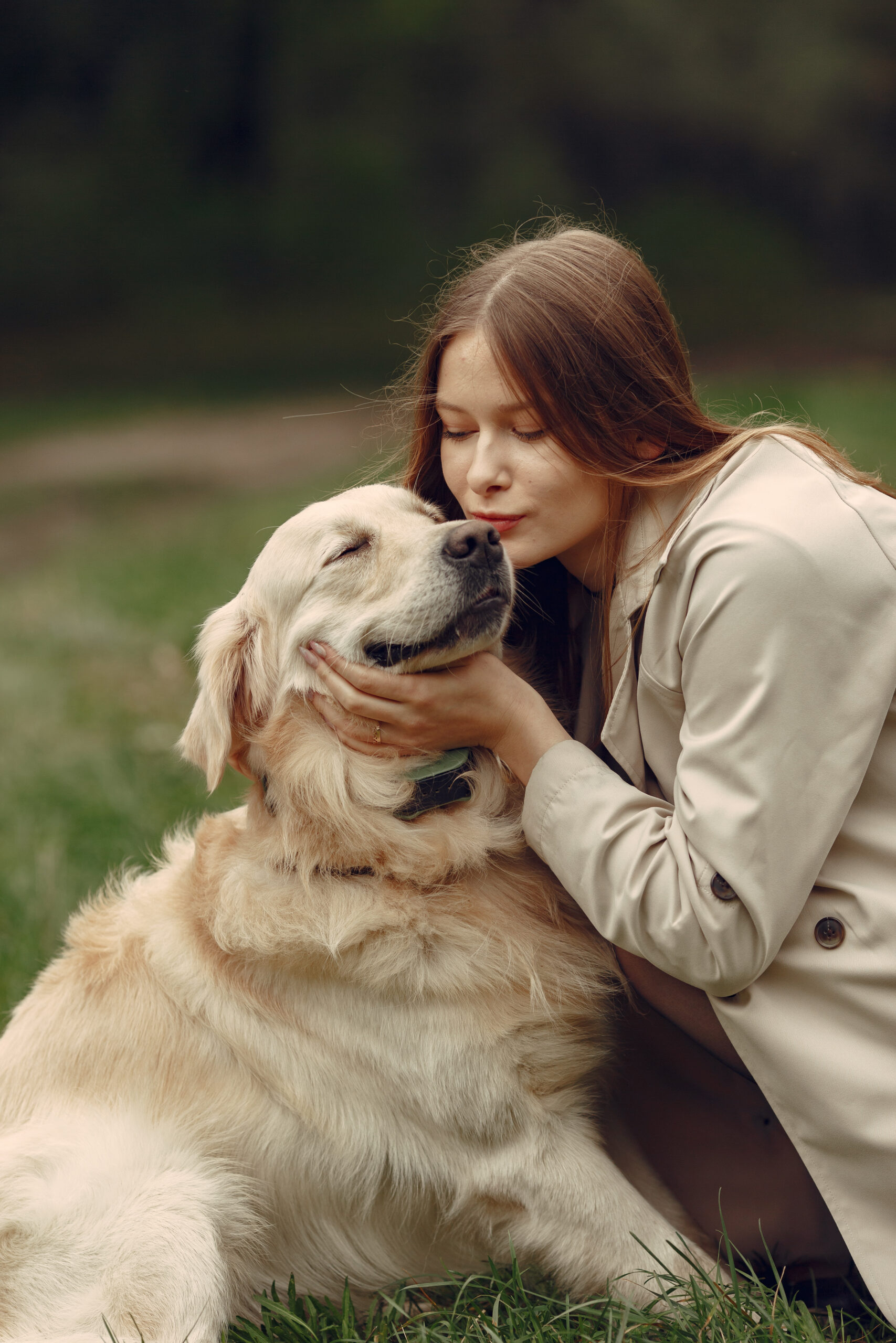 Woman in a brown coat. Lady with a labrador. Friends are having fun outside.